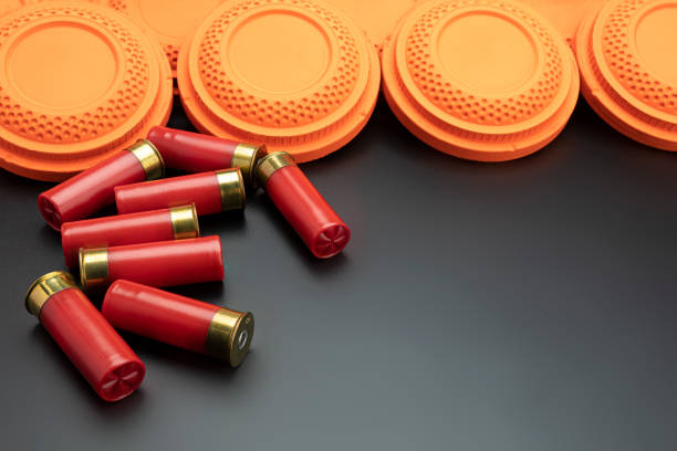 istock Clay disc flying targets and shotgun bullets on black background ,Clay Pigeon target 1329139546