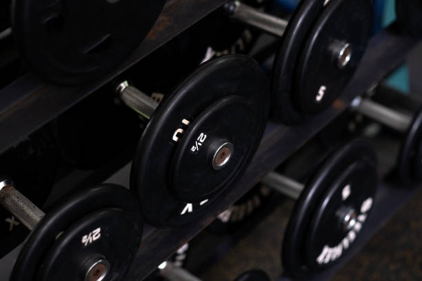 istock black dumbbells in Dark gym interior 1329140256