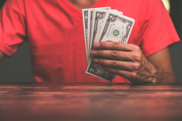 istock Business people hold cash notes 1329140276