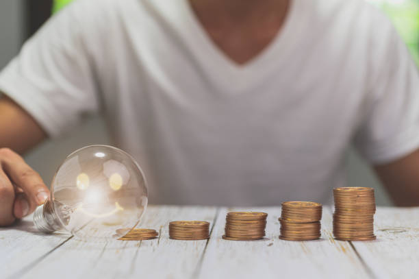 istock businessman holding lightbulb money stack idea saving energy and accounting finance 1329140308