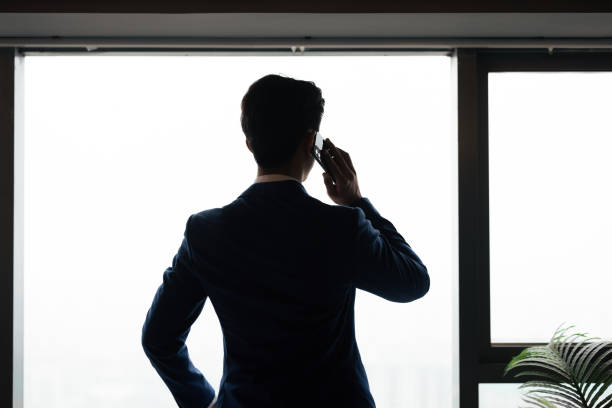 istock Asian business man standing by the window 1329140476