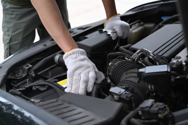 istock Cropped shot mechanics working on car engine in mechanics garage. 1329145829