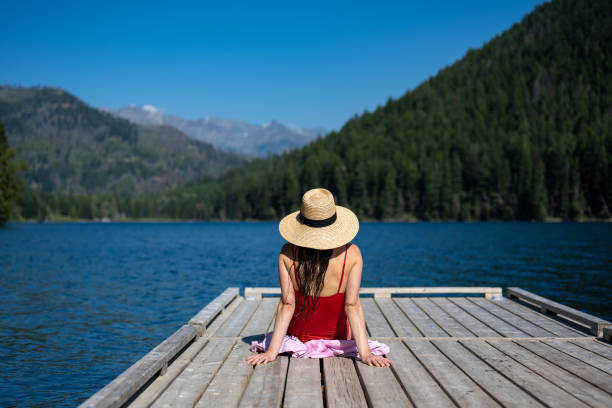 istock Woman relaxing at the lake 1329146041