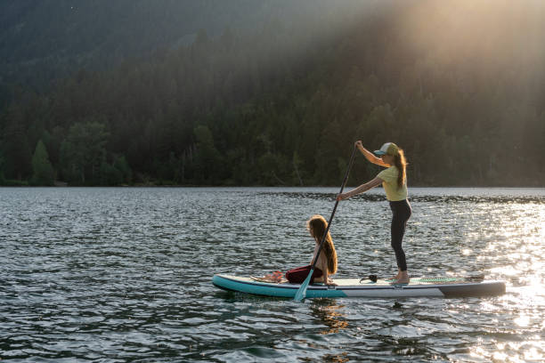 istock Mother and daughter on a paddle board adventure 1329146086