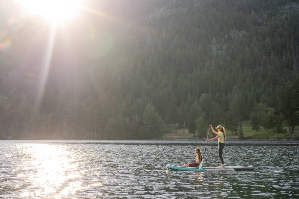 istock Mother and daughter on a paddle board adventure 1329146102