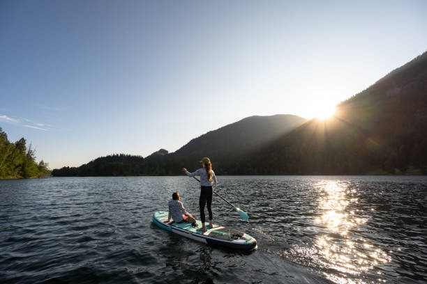 istock Mother and daughter on a paddle board adventure 1329146709