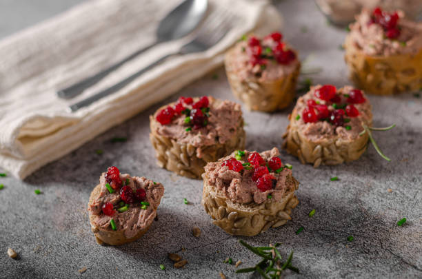 Homemade pate on heathy bread with cranberries Delicious homemade pate with wholegrain pastry and herbs heathy snack stock pictures, royalty-free photos & images