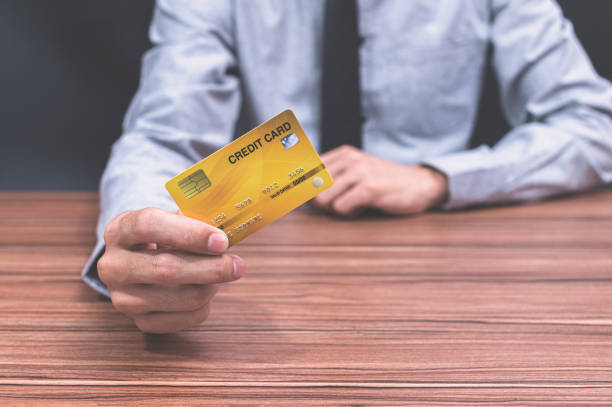 istock A man holding a credit card 1329149362