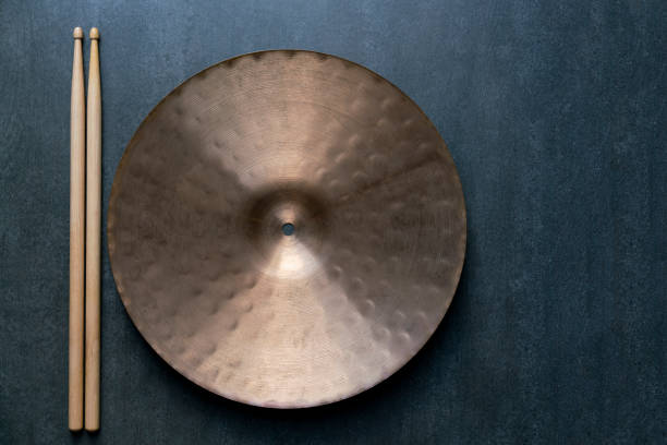 Drum stick and crash cymbal on black table background, top view, music concept Drum stick and crash cymbal on black table background, top view, music concept drum percussion instrument photos stock pictures, royalty-free photos & images