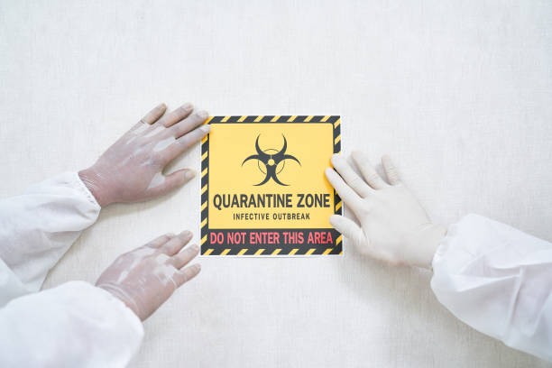 istock Quarantine zone plate sign on wall with doctor protection suit a 1329151685