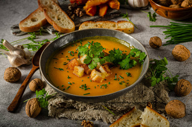 istock Pumpkin soup with herbs and crispy toast 1329152017