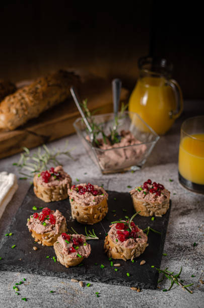 Homemade pate on heathy bread with cranberries Delicious homemade pate with wholegrain pastry and herbs heathy snack stock pictures, royalty-free photos & images