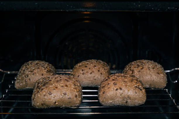 Fresh and healthy baked brown delicious multigrain rolls on the rack in the oven