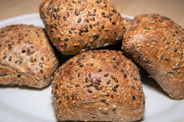 4 pieces of freshly baked, healthy and delicious multigrain rolls on a plate