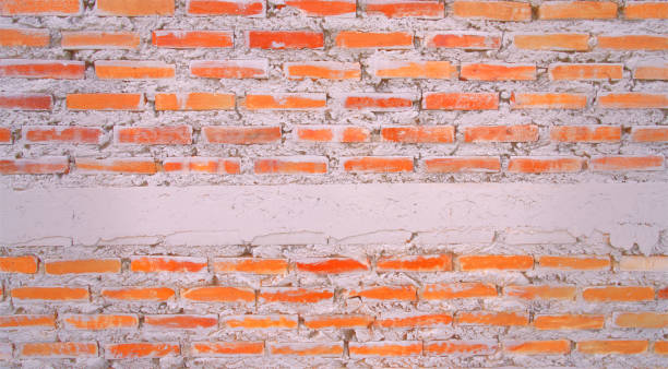 empty old brick wall painted texture happy red-brown wall wide grunge brick wall shabby building with damaged plaster abstract web banner white copy space draped over. - color image solid brown bumpy imagens e fotografias de stock