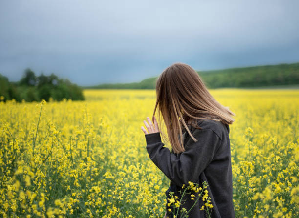 istock Young girl on yellow rapeseed field 1329160907