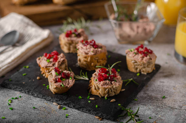 Homemade pate on heathy bread with cranberries Delicious homemade pate with wholegrain pastry and herbs heathy snack stock pictures, royalty-free photos & images