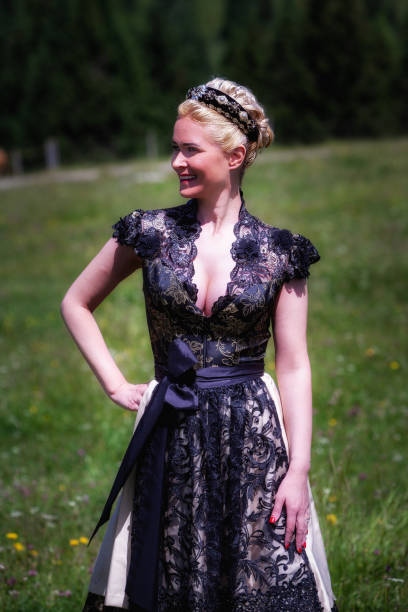 istock Blonde woman in black dirndl dress 1329169057