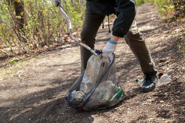istock Man in white gloves collects plastic dishes in bag 1329169067
