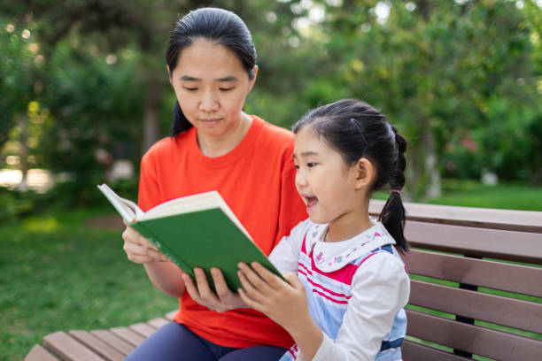 istock Little Girl and Mother Reading Book 1329169248