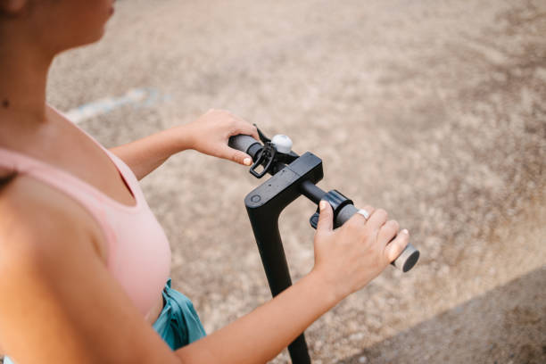 istock Woman holding electric scooter handlebars 1329173410