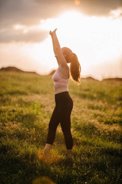 istock Woman stretching on the meadow 1329174067