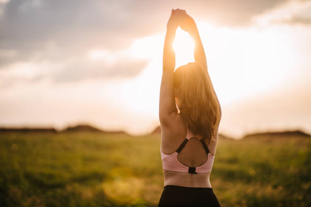 istock Woman stretching on the meadow 1329174070