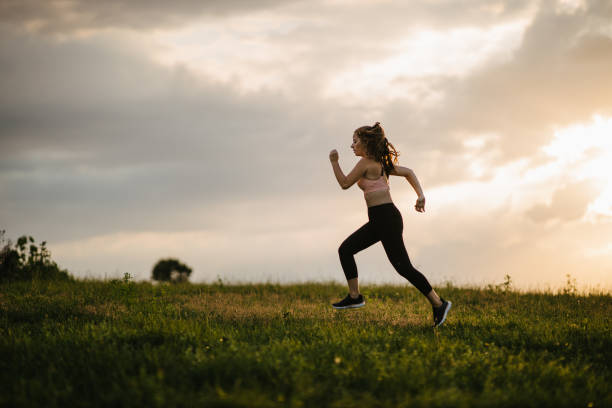 istock Woman jogging on the meadow 1329174387
