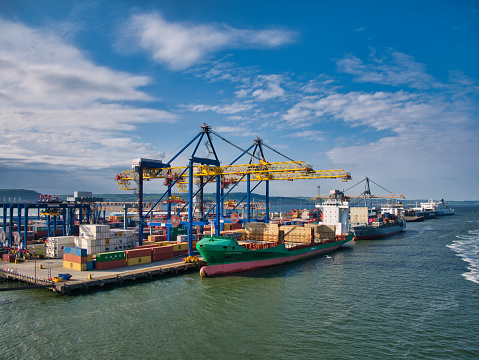 Container ships loading and unloading at the Belfast Harbour container terminal on a sunny evening in June 2021