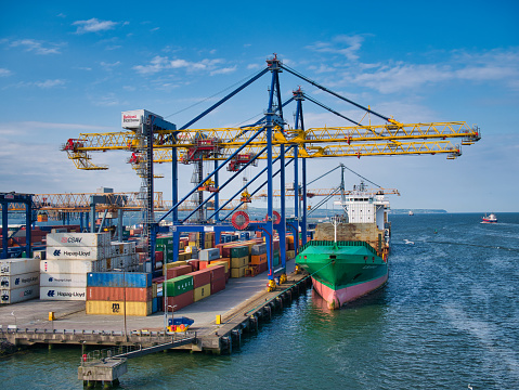 Container ships loading and unloading at the Belfast Harbour container terminal on a sunny evening in June 2021