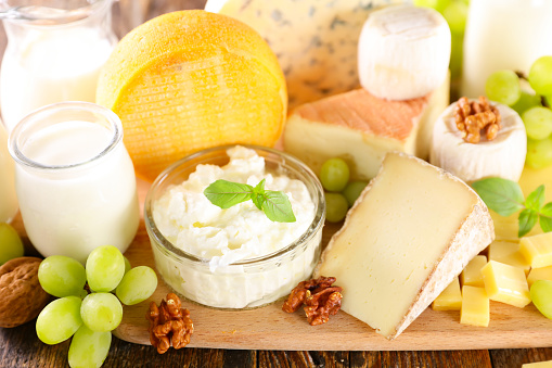 set of dairy products on wooden board
