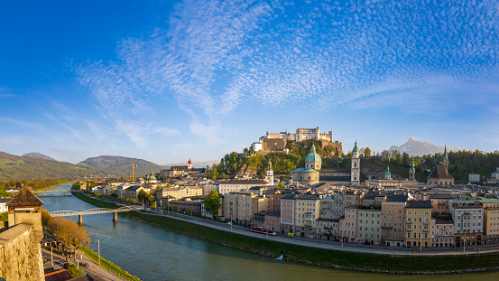 Salzburg, Salzburg - Austria - 06-17-2021: Elevated view of Salzburg with Hohensalzburg Fortress dominating the skyline amidst green hills