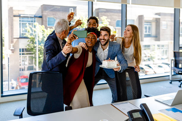 istock Friendly Multi-Ethnic Employees are Celebrating Birthday Together and Taking a Selfie. 1329180197