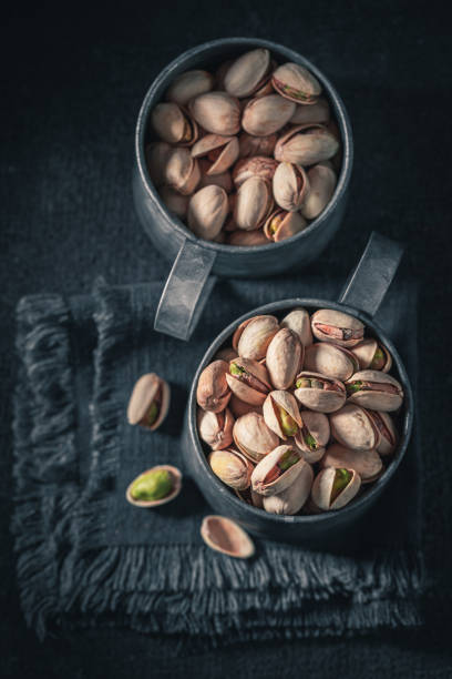 Group of pistachios on dark table. Source of minerals.