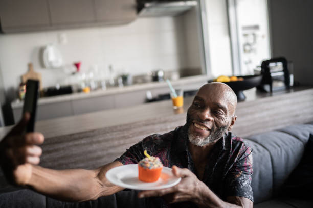 istock Mature man celebrating birthday doing a video call on smartphone at home 1329183068