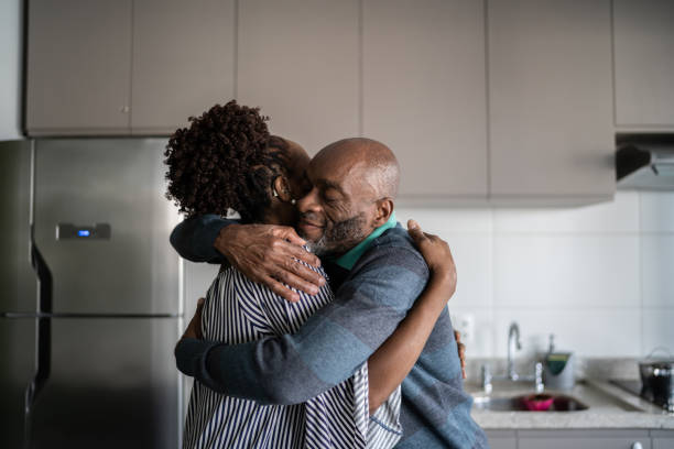 istock Mature couple embracing at home 1329183187