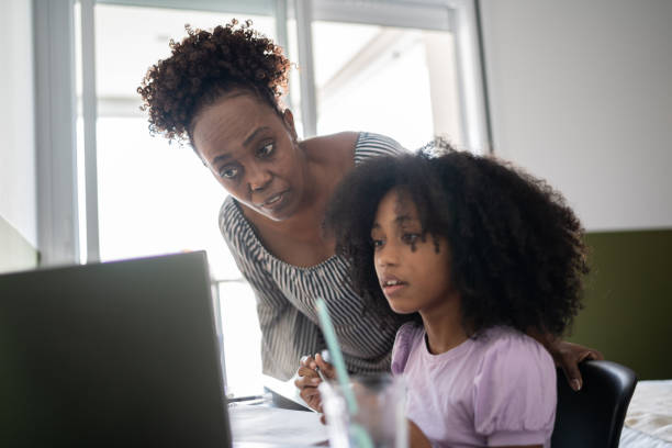 istock Mother helping daughter with homework 1329183188