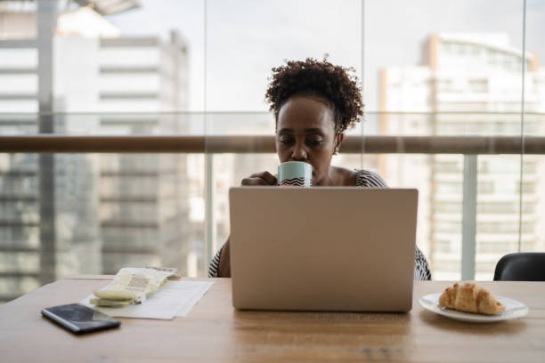 istock Mature woman using laptop working at home 1329183249