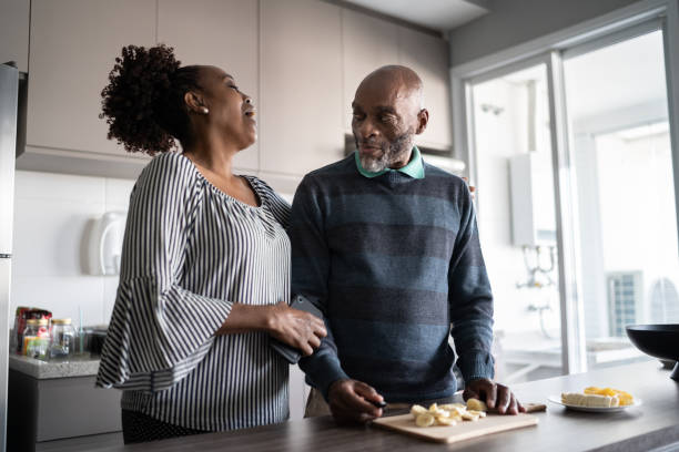 istock Couple cutting cheese and talking at home 1329183267
