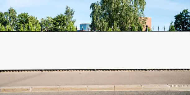 Photo of Advertising empty long white billboard with space for mockup information