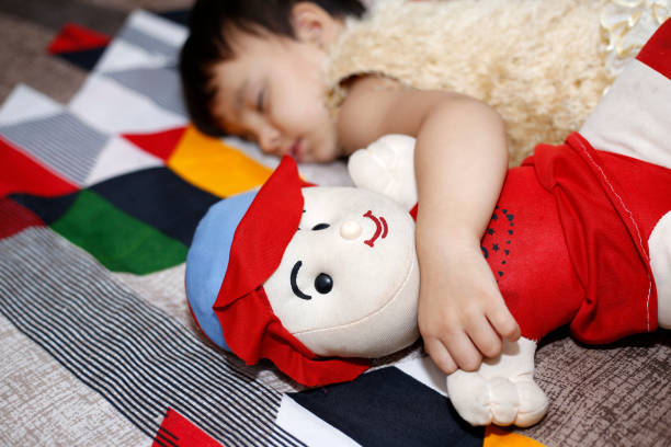 istock Innocent baby girl sleeping on bed 1329185427