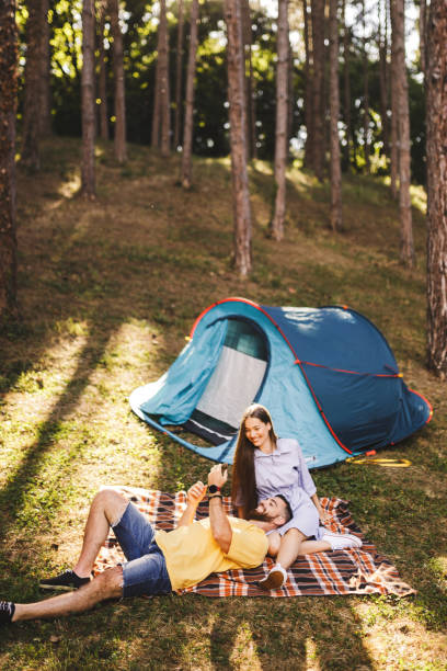 istock Romantic couple enjoying while camping in forest 1329185505