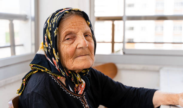 Elderly woman sitting alone and looking