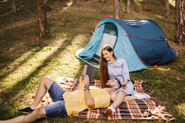istock Romantic couple enjoying while camping in forest 1329186935