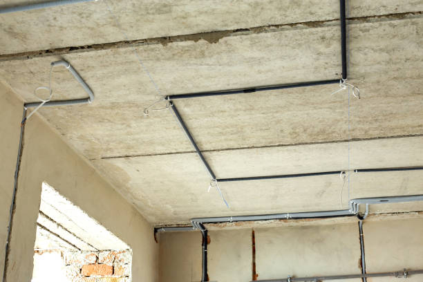 istock Electrical cables laid in protective corrugation installed on the ceiling and wall in a room under construction works. 1329188079