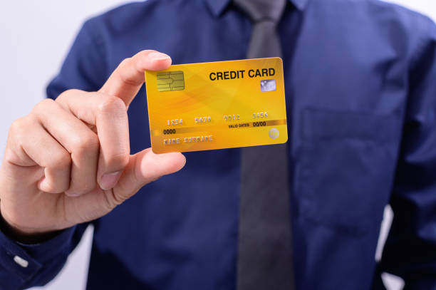 istock Business people hold credit cards 1329188538