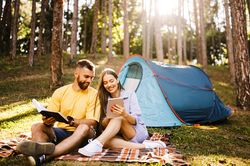 Romantic couple enjoying while camping in forest