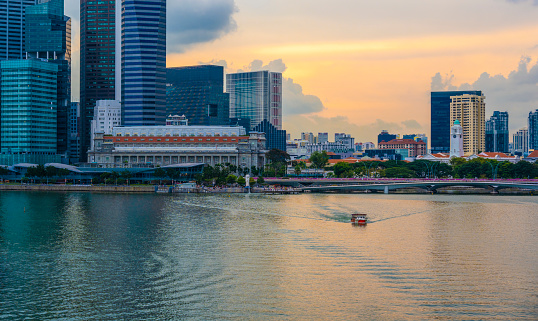 Aerial view of skyscrapers and other buildings seen in the financial district of Marina Bay in Singapore. In front the Singapore River. Seen at sunset.