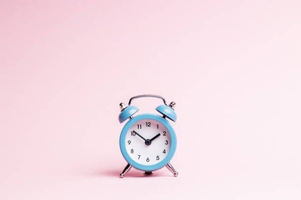 istock blue alarm clock over pink background. outer space. minimal. time planning concept 1329190567