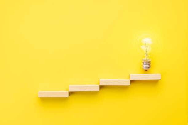 istock abstract business strategy concept. steps to idea symbol shown as light bulb over yellow background. inspiration and innovation conceptual 1329190592